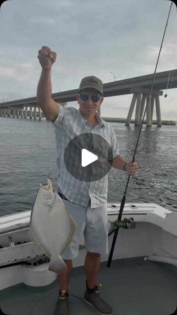 An adult angler holding a fluke aboard the boat near the Shinnecock bridge